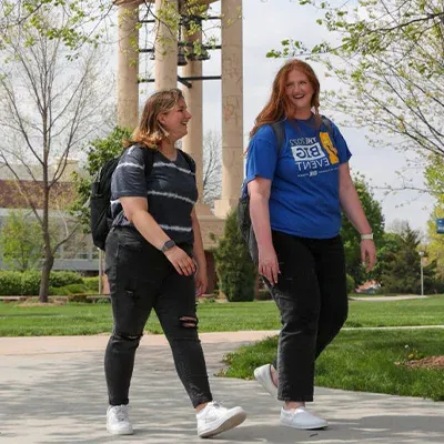 two students walk across campus